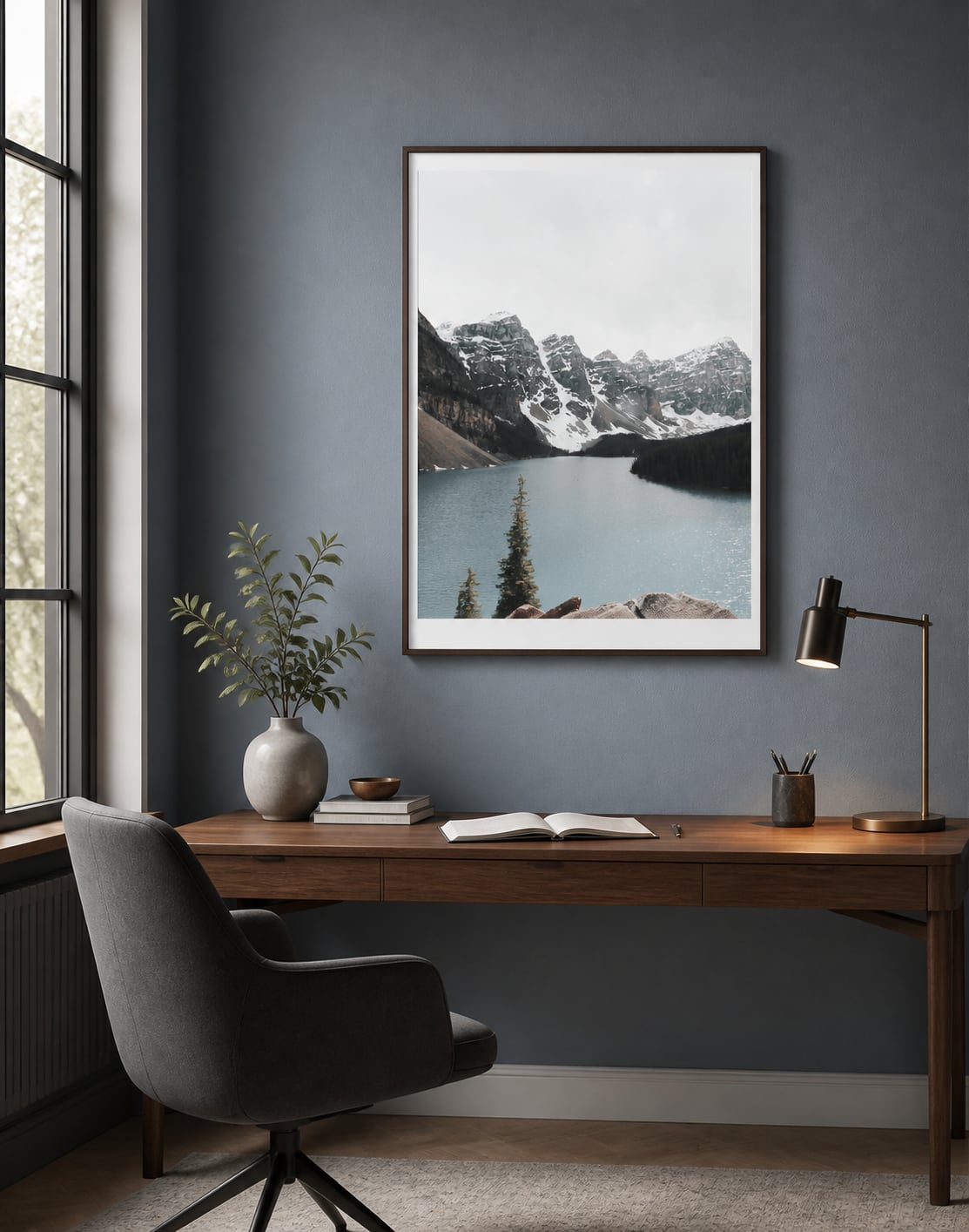 Cool mountain-lake print above a walnut desk in a blue-gray home office