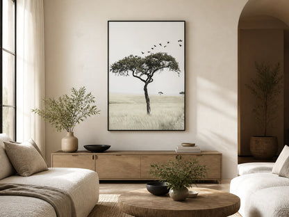 Lone tree and birds print above pale oak furniture in a warm neutral living room