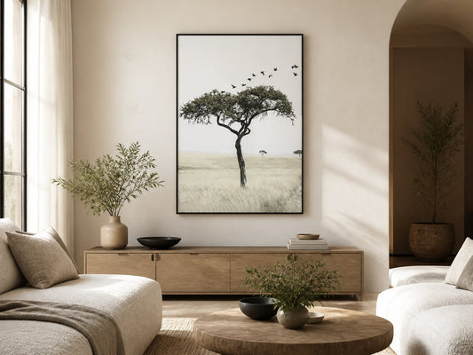 Lone tree and birds print above pale oak furniture in a warm neutral living room