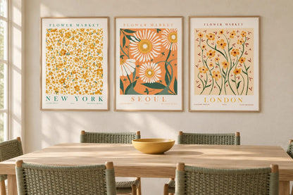 Yellow-orange floral triptych above a light dining table with woven chairs.