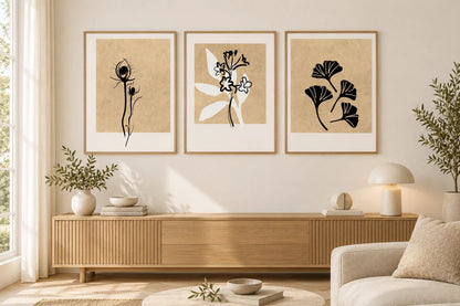 Botanical triptych above a light oak dresser in a living room.
