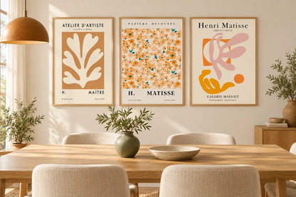Botanical triptych displayed in a light dining room.