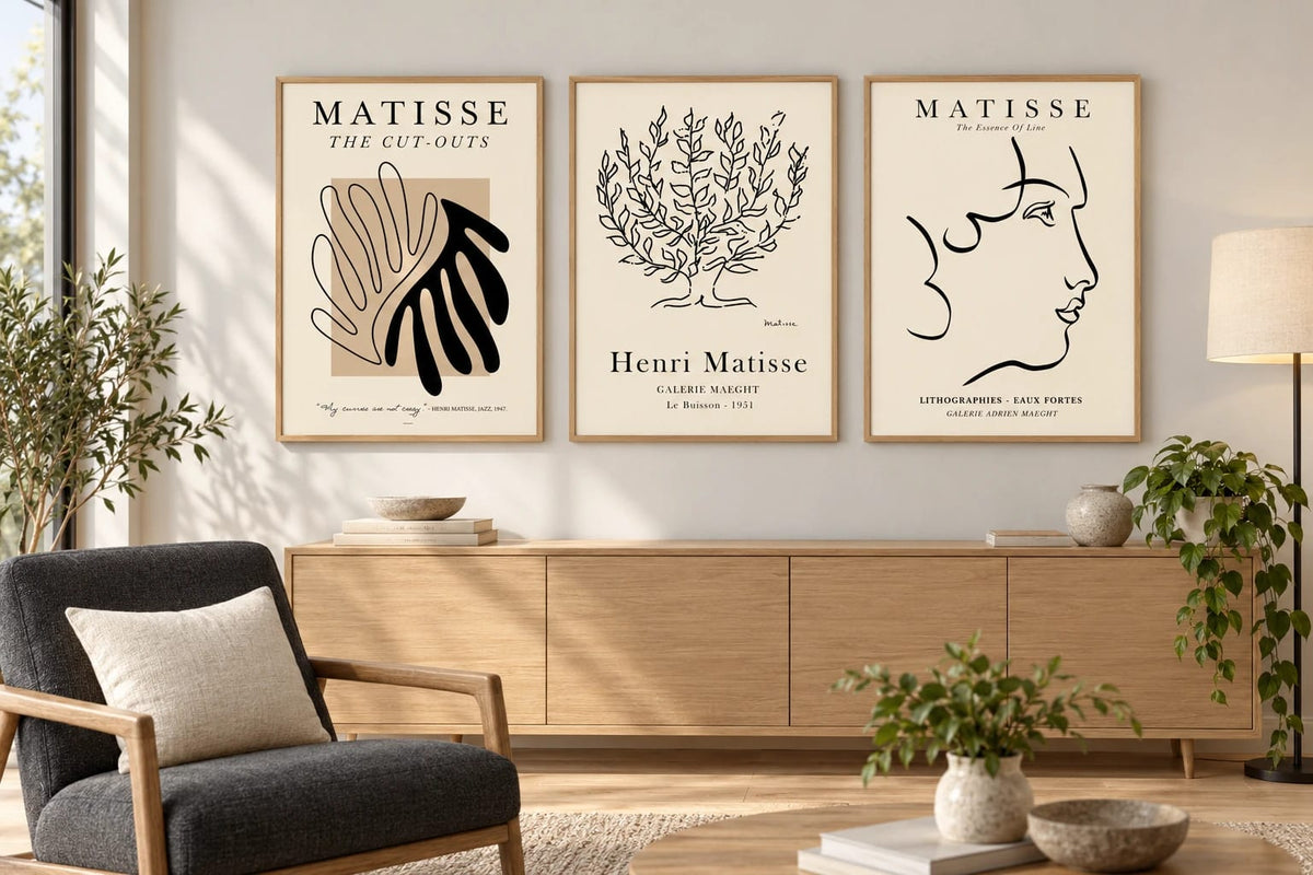 Neutral botanical triptych above an oak dresser in a living room.