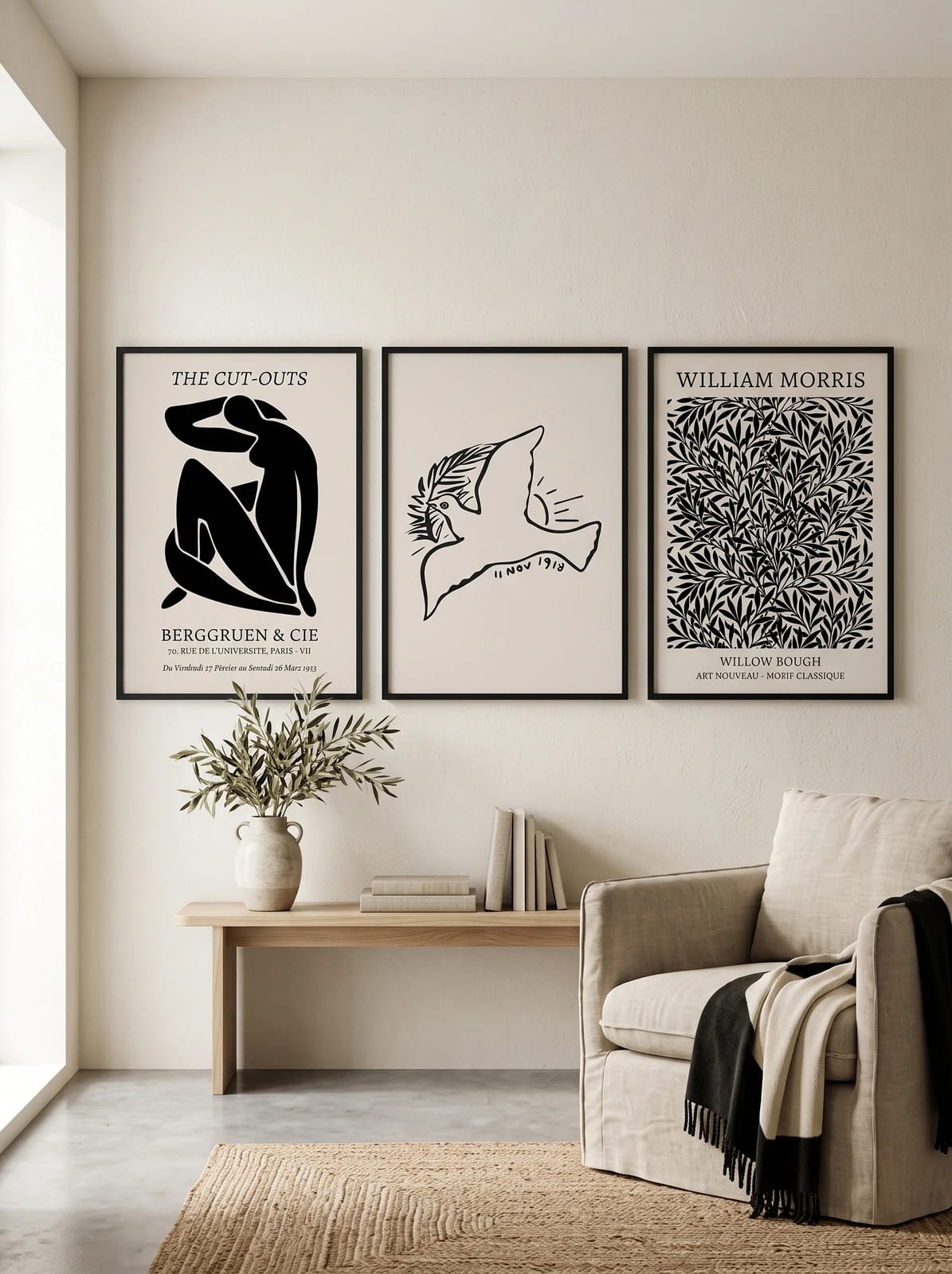 Three black and cream prints grouped on a neutral wall.