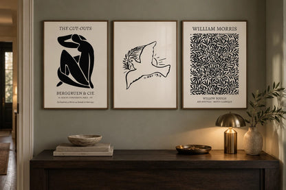 A botanical and bird print set arranged in a bedroom.