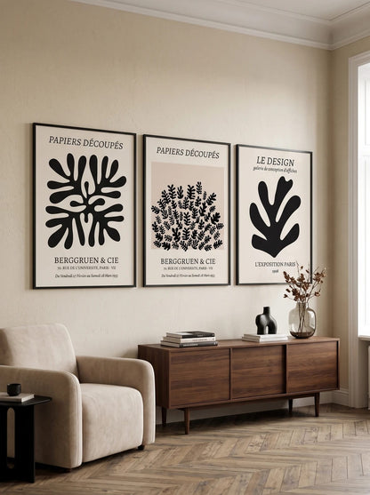 Three graphic botanical prints arranged together on a light wall.