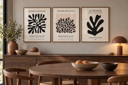 A cut-paper leaf print set displayed in a work area.