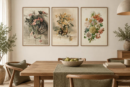 Flower prints displayed in a light dining room with an oak table.