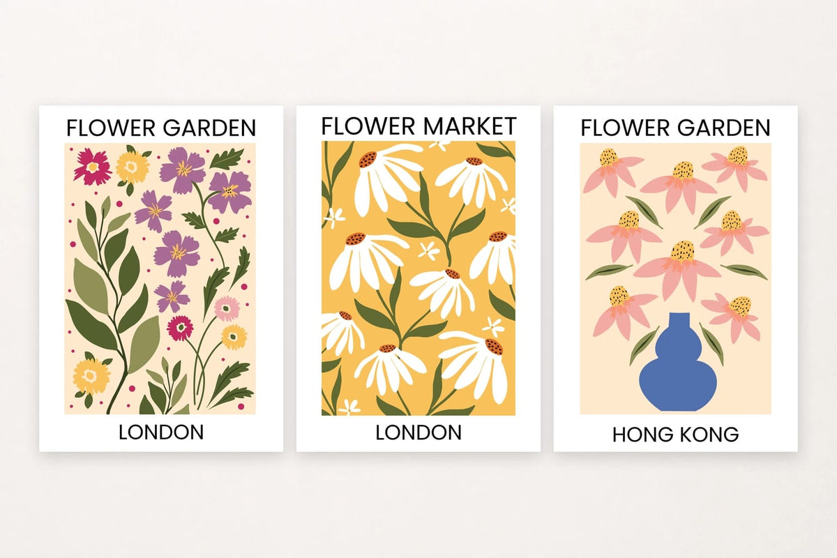 Three flower prints with London lettering, white blooms on mustard, and pink flowers by a blue vase.