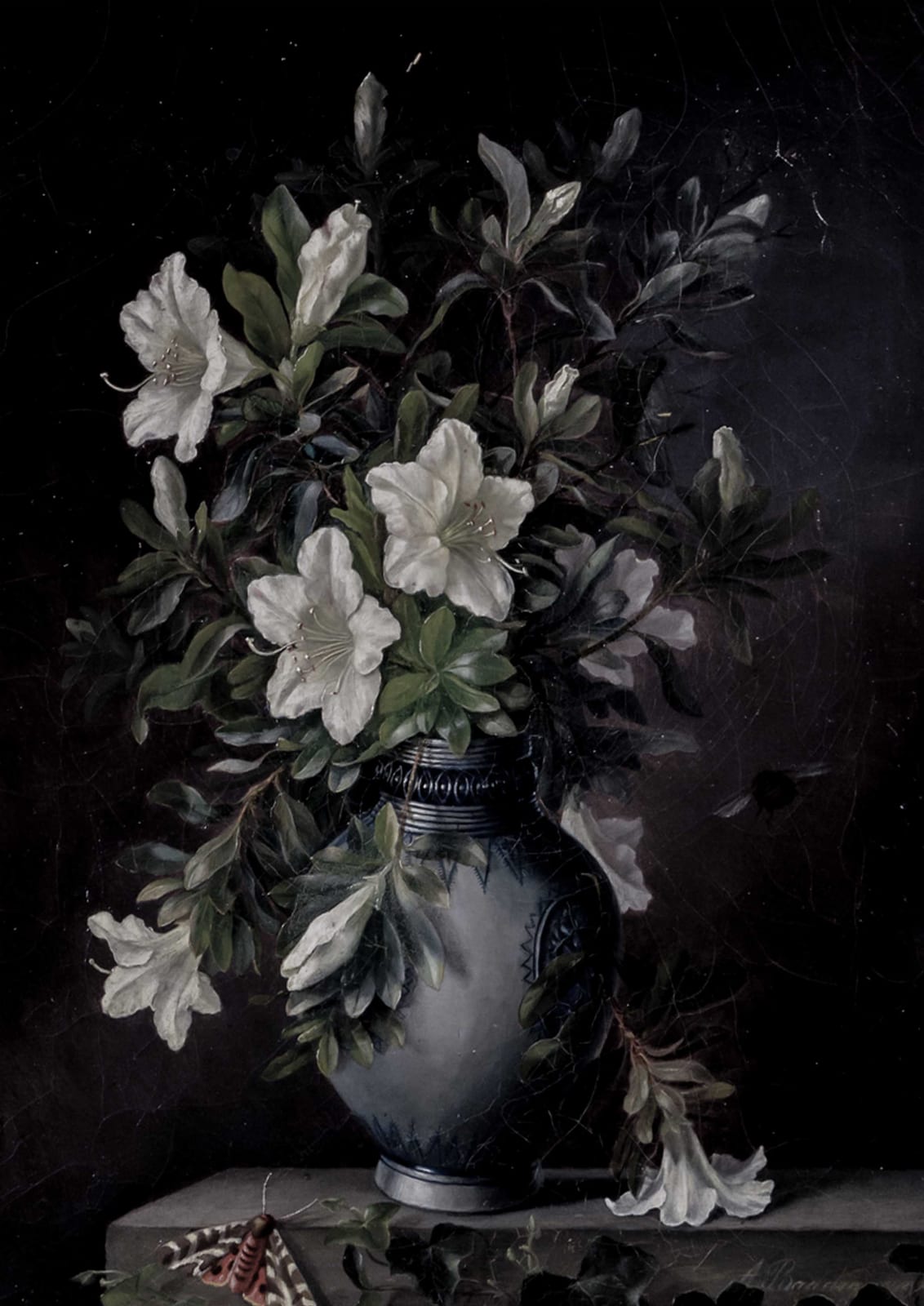 White flowers sit in a gray-blue vase.
