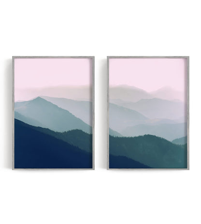 Two layered blue-green mountain panels beneath a muted rose and cream sky
