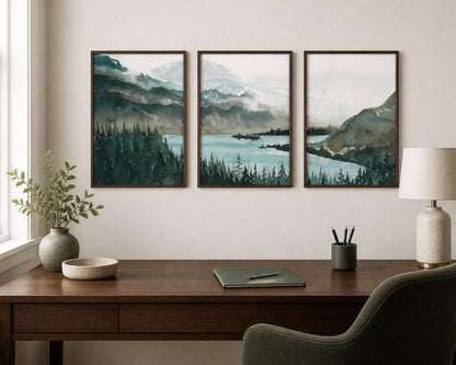 Deep green mountain-lake triptych above a dark-walnut desk in a warm white office