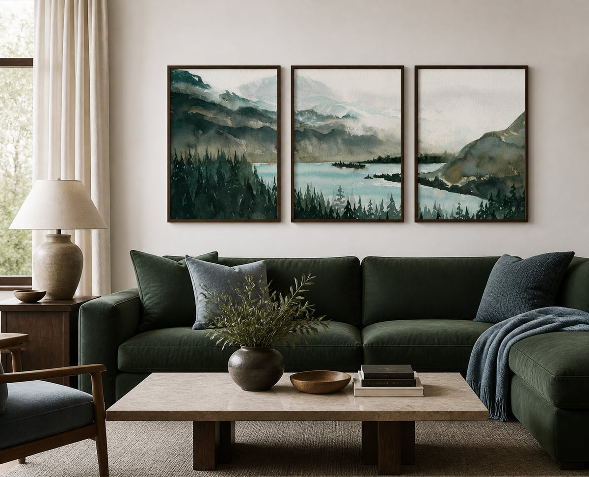 Deep green mountain-lake triptych above a forest-green sofa with blue-gray accents
