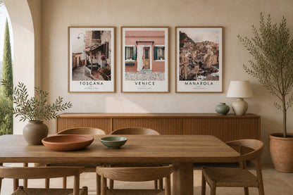 Travel triptych above a walnut sideboard in a cream and terracotta dining room