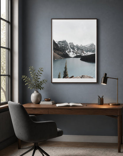 Cool mountain-lake print above a walnut desk in a blue-gray home office