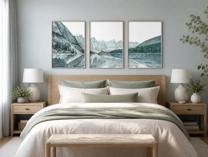 Pale mountain-lake triptych above an ivory bed with sage textiles