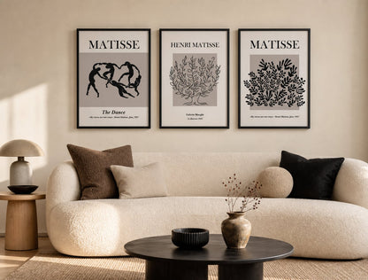 Neutral modernist triptych in a cream living room with mushroom and black accents