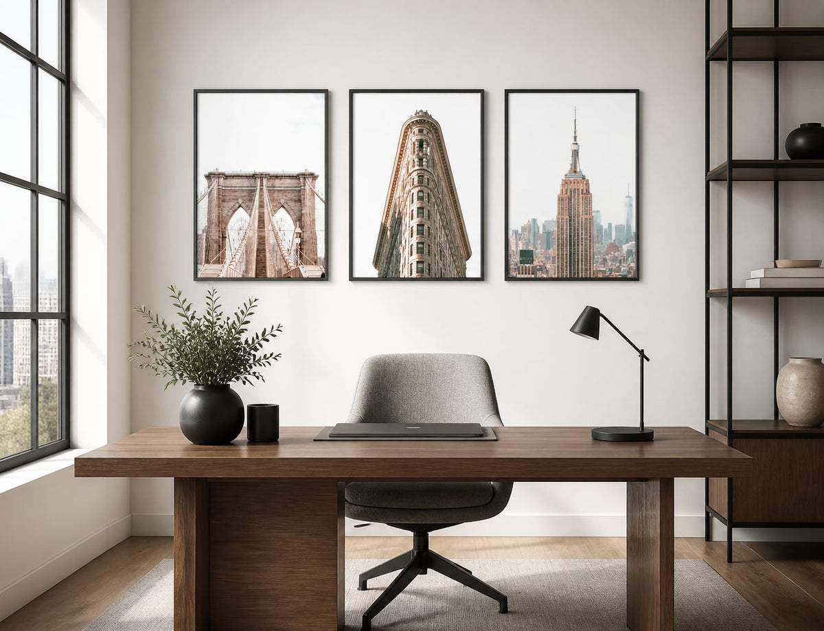 Architectural city triptych above a walnut desk in a black-and-white office