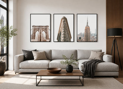Architectural city triptych in a gray, walnut, and black living room
