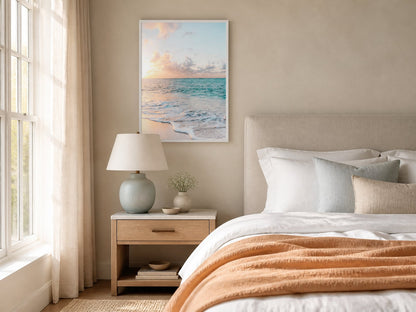 Pastel ocean horizon print in an ivory bedroom with peach and blue-gray textiles
