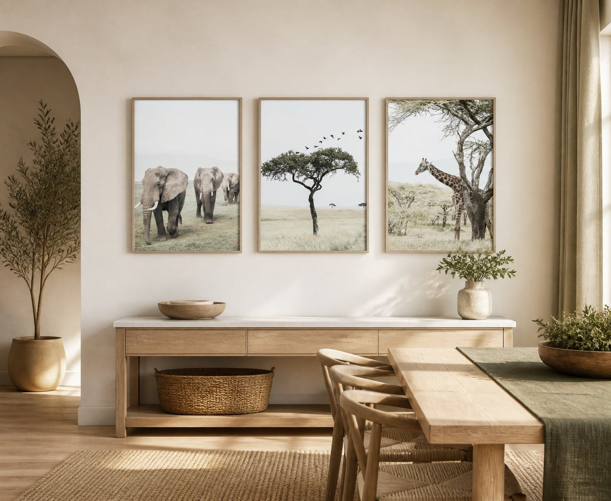 Neutral wildlife triptych above a pale-oak console beside an open dining area