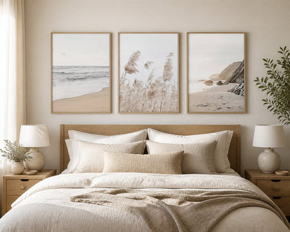 Neutral coastal triptych above an ivory bed with pale oak and sand textiles