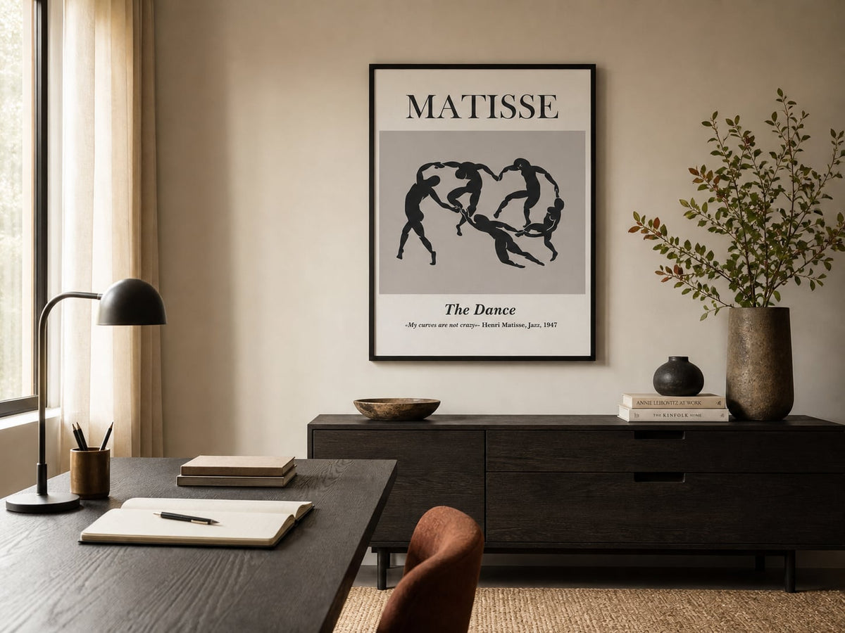 Black-and-cream linked-figure poster in a warm neutral home office