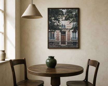 Montmartre Doorway Print above a walnut dining table in a warm cream room