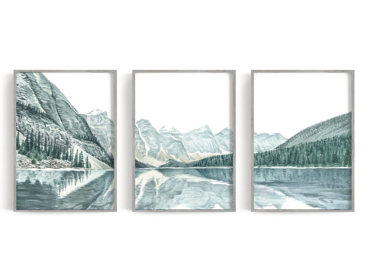 Three watercolor-style mountain lake prints in blue, gray, and white