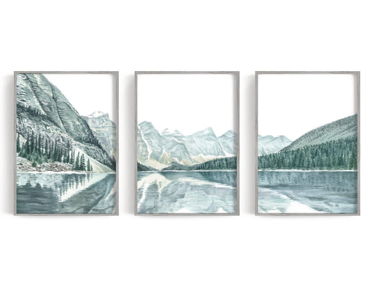 Three watercolor-style mountain lake prints in blue, gray, and white