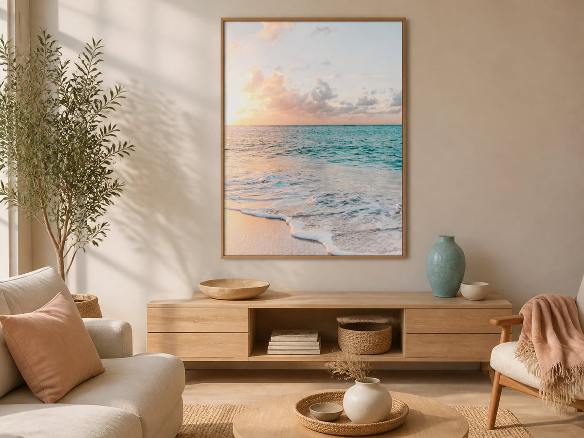 Pastel ocean horizon print above a light-oak console in a peach and turquoise living room