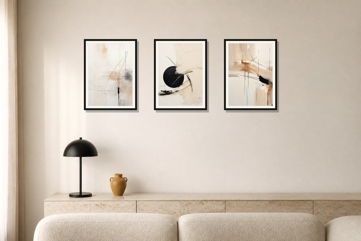 Quiet Geometry Abstract Trio trio displayed in a living room matched to its warm ivory, black, ochre palette