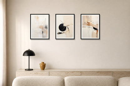 Quiet Geometry Abstract Trio trio displayed in a living room matched to its warm ivory, black, ochre palette