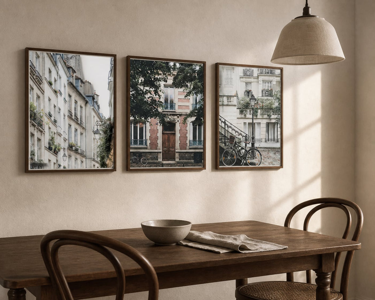 Quiet Paris Streets Trio above a walnut dining table in a warm European-style room