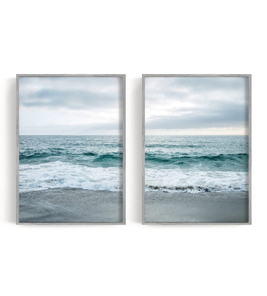 Two blue-gray shoreline prints with pale surf and a quiet coastal horizon