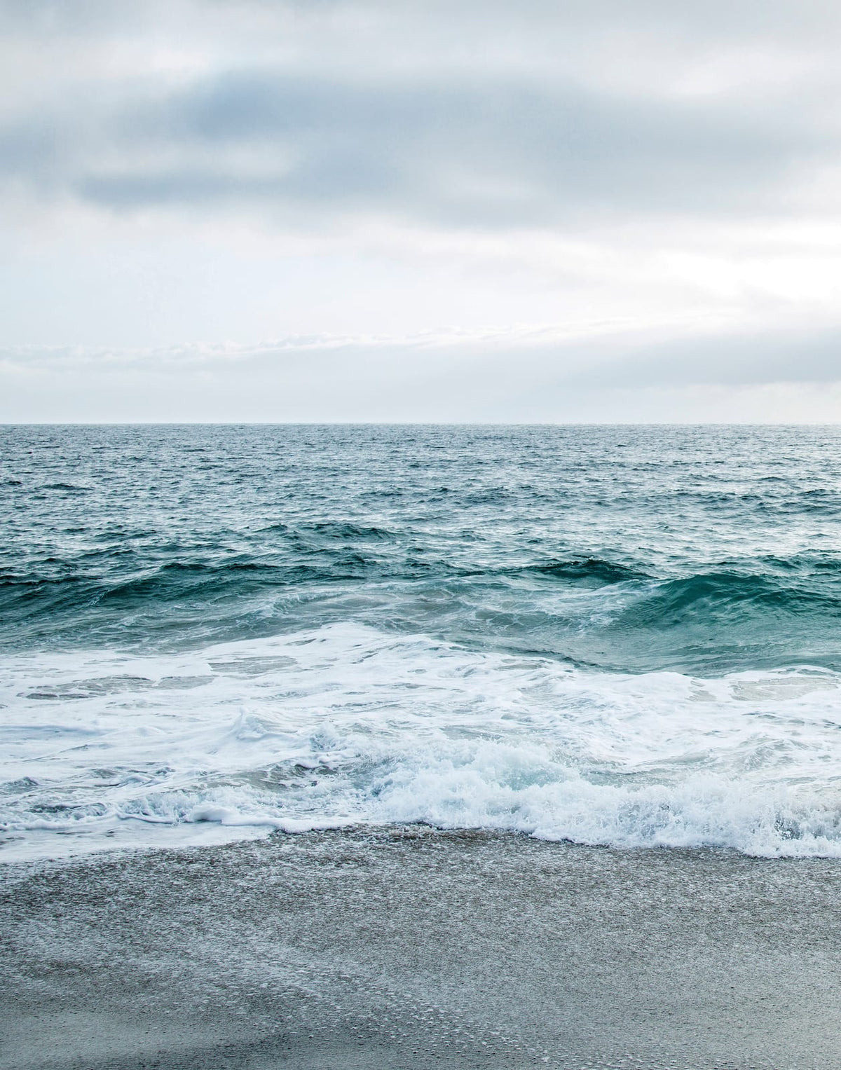 Two blue-gray shoreline prints with pale surf and a quiet coastal horizon, panel 1 of 2