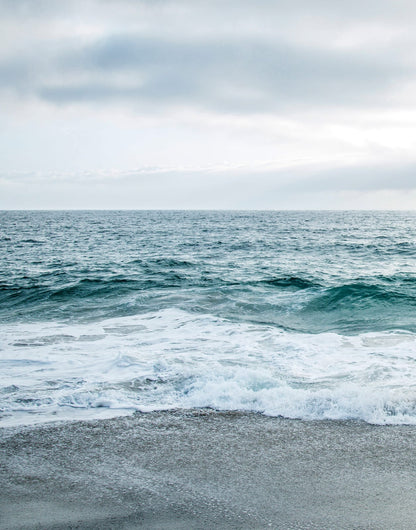 Two blue-gray shoreline prints with pale surf and a quiet coastal horizon, panel 1 of 2