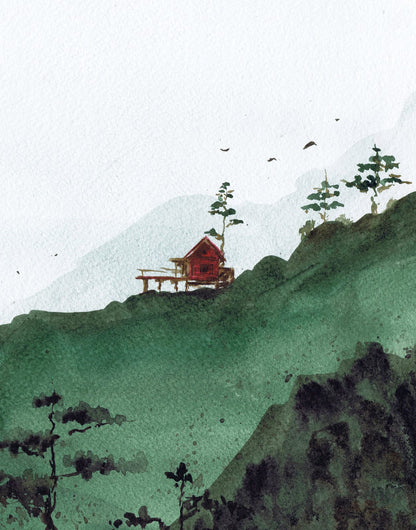 Small red cabin below dark green mountain forms
