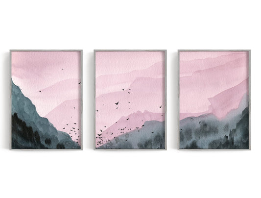 Three layered mountains in dusty rose and charcoal with birds crossing the center