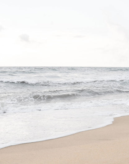 Coastal print with open water and a pale sandy shoreline