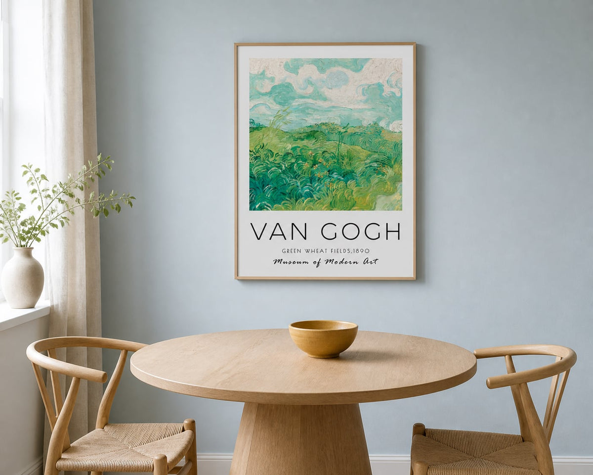 Van Gogh Green Fields Print above a light oak table in a pale blue dining nook