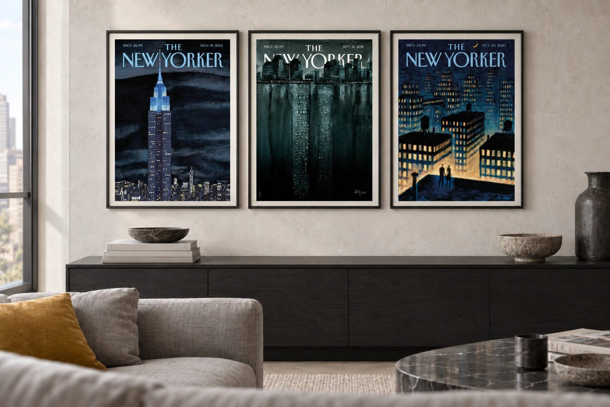 Three night scenes hang against a light stone wall in a modern living room.