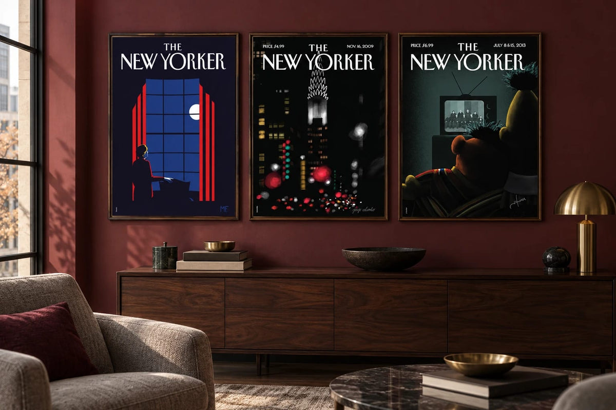Three dark city scenes hang on a burgundy living room wall.