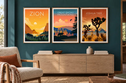 Three landscapes hang above a light cabinet on a dark teal wall.