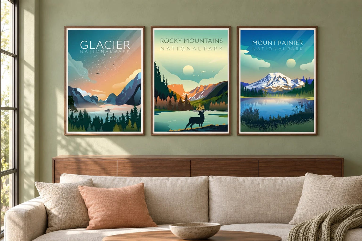 Three mountain park prints hang on a sage wall above a walnut cabinet and light sofa.