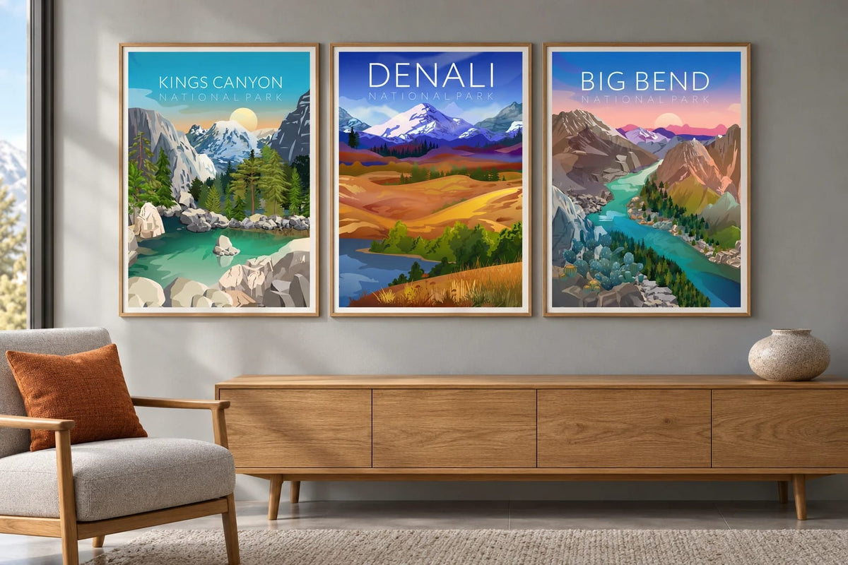 Three canyon and mountain prints hang above an oak cabinet beside an orange pillow.