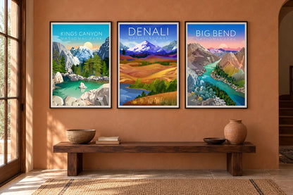 Three landscapes hang above a dark wood console on a terracotta entryway wall.