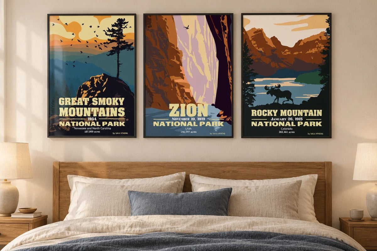 Mountain triptych above a wood bed with linen and a blue throw.
