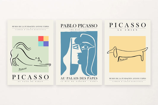Three graphic prints with a cat, two faces, and a long dog.