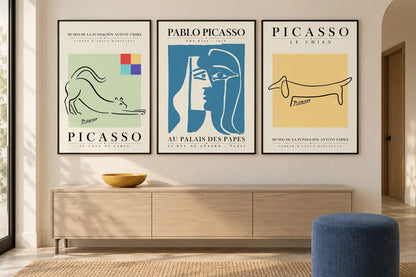 Cat, face, and dog prints above a light oak console and blue ottoman.